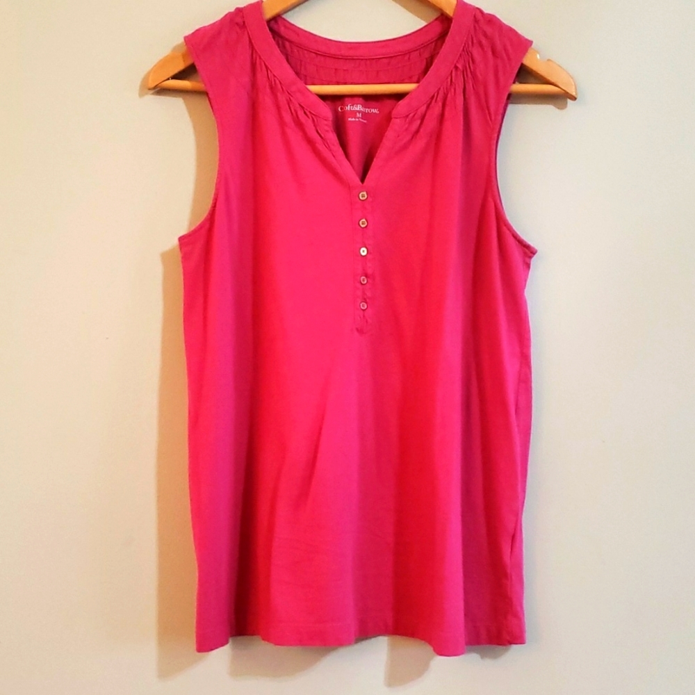 We are selling a pink tank top with a very low cut and buttons.